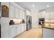 A well-lit kitchen features stainless steel appliances, granite countertops and ample cabinet space at 13897 Umbria St, Venice, FL 34293