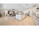 Open concept kitchen with island, seating, and stainless steel appliances at 13897 Umbria St, Venice, FL 34293