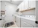 Laundry room featuring washer, dryer, sink, and storage cabinets at 13897 Umbria St, Venice, FL 34293