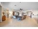 Spacious living room with neutral tones, tile flooring, and an open layout, perfect for entertaining guests at 13897 Umbria St, Venice, FL 34293