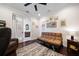 Comfortable home office with hardwood floors, a cozy futon, and stylish decor at 13897 Umbria St, Venice, FL 34293