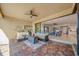 Covered patio with a built-in bar, seating area, ceiling fan, and tiled flooring at 13897 Umbria St, Venice, FL 34293
