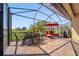 Relaxing screened patio with dining and lounge seating, ideal for enjoying the outdoor breeze at 13897 Umbria St, Venice, FL 34293