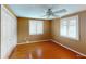 Bright bedroom with hardwood floors, ceiling fan, and plantation shutters at 1460 Everest Rd, Venice, FL 34293