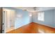Cozy bedroom featuring hardwood flooring and large windows, painted in light blue tones at 1460 Everest Rd, Venice, FL 34293