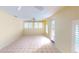 Spacious bedroom with tile flooring, ceiling fan, and bright windows at 1460 Everest Rd, Venice, FL 34293