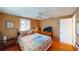 Bright bedroom with hardwood floors, large windows, and a cozy bed, creating a comfortable and inviting space at 1460 Everest Rd, Venice, FL 34293