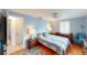 Cozy bedroom with blue walls, wood floors, and a comfy bed, offering a serene retreat at 1460 Everest Rd, Venice, FL 34293