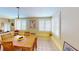 Sunny dining area featuring tile floors, plantation shutters, and a wooden table that provides a cozy space for meals at 1460 Everest Rd, Venice, FL 34293