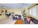 Bright living room with tile floors, ceiling fans, comfortable seating, and ample natural light at 1460 Everest Rd, Venice, FL 34293