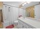 Full bathroom featuring a shower/tub combo, neutral tile, and a single sink vanity at 1555 Tarpon Center Dr # 156, Venice, FL 34285