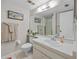 Well-lit bathroom featuring a vanity, large mirror, and a shower with glass doors at 1555 Tarpon Center Dr # 156, Venice, FL 34285