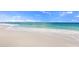 Expansive beach view featuring the shoreline, turquoise waters, and clear blue skies with scattered clouds at 1555 Tarpon Center Dr # 156, Venice, FL 34285