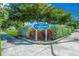 Welcome to Centennial Park, beautifully landscaped with lush greenery and mature trees near a brick-paved sidewalk at 1555 Tarpon Center Dr # 156, Venice, FL 34285