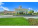 The Venice Community Center showcases a landscaped entrance with a bright green lawn and a terracotta roof at 1555 Tarpon Center Dr # 156, Venice, FL 34285