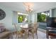 Cozy dining area with a window view, a stylish chandelier and room to entertain at 1555 Tarpon Center Dr # 156, Venice, FL 34285