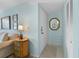 Warm entryway with a mirror, side table and white closet door in a calming color palette at 1555 Tarpon Center Dr # 156, Venice, FL 34285