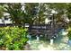 Scenic view of a community bridge, surrounded by water and lush tropical landscaping at 1555 Tarpon Center Dr # 156, Venice, FL 34285