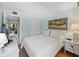 Comfortable bedroom featuring a view of the hallway to the balcony, complemented by neutral tones and hardwood floors at 1555 Tarpon Center Dr # 156, Venice, FL 34285