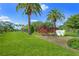 Scenic view of Wellfield Park, featuring lush green lawns, mature trees, and a charming gazebo at 1555 Tarpon Center Dr # 156, Venice, FL 34285