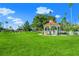 A picturesque gazebo is surrounded by sprawling green grass and swaying palm trees at 1555 Tarpon Center Dr # 156, Venice, FL 34285