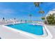 Beautiful pool and sun deck with palm trees and chairs overlooking the ocean at 1555 Tarpon Center Dr # 156, Venice, FL 34285