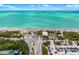 Captivating aerial view capturing the beach, parking area, and roads at 1585 Keyway Ct, Englewood, FL 34223