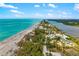 Gorgeous aerial view of waterfront homes on a peninsula, surrounded by lush trees and blue waters at 1585 Keyway Ct, Englewood, FL 34223