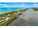 Stunning aerial view of coastal neighborhood between the Gulf and a tranquil channel at 1585 Keyway Ct, Englewood, FL 34223