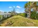 Well-maintained backyard with a fire pit, lush landscaping, and secure fencing at 1585 Keyway Ct, Englewood, FL 34223