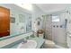 Bathroom featuring blue and white tiles, a vanity with a mirror, and a shower/tub combination with a patterned curtain at 1585 Keyway Ct, Englewood, FL 34223