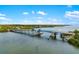 Scenic aerial view of a vibrant blue bridge spanning a waterway on a sunny day at 1585 Keyway Ct, Englewood, FL 34223