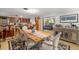 Inviting dining area adjacent to the kitchen with a wooden table, seating for six, and a stylish rug at 1585 Keyway Ct, Englewood, FL 34223