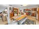 Dining area with a modern table, bench seating, vintage furniture, and decorative accents, open to kitchen at 1585 Keyway Ct, Englewood, FL 34223