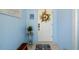 Charming front door with welcome mat and decorative floral wreath at 1585 Keyway Ct, Englewood, FL 34223