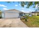 Charming single-story home with a well-manicured lawn, attached garage, and inviting front entrance at 1585 Keyway Ct, Englewood, FL 34223