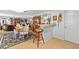 Open-concept living room featuring tile floors, casual seating, and an adjacent breakfast bar area with a wooden stool at 1585 Keyway Ct, Englewood, FL 34223