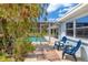 Charming backyard patio with comfortable seating and access to the refreshing screened pool at 1585 Keyway Ct, Englewood, FL 34223
