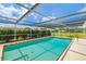 Screened pool with crystal clear water and mature landscaping offers a serene outdoor retreat at 1585 Keyway Ct, Englewood, FL 34223