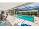 Inviting screened-in pool area with clear blue water, seating, and well-maintained deck for outdoor relaxation at 1585 Keyway Ct, Englewood, FL 34223