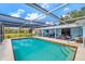 Relaxing screened-in pool area with patio furniture, perfect for entertaining and enjoying the outdoors at 1585 Keyway Ct, Englewood, FL 34223