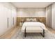 Tranquil main bedroom featuring hardwood floors, a wooden accent wall, and a large closet at 1804 Nimbus Dr, North Port, FL 34287