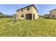 Expansive backyard with a swing set, perfect for outdoor activities and Gathering fun at 1951 E Isles Rd, Port Charlotte, FL 33953
