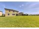 Lush backyard overlooking a serene pond, providing a tranquil and picturesque setting at 1951 E Isles Rd, Port Charlotte, FL 33953