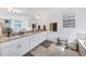 Bright bathroom featuring double sinks, granite counters, and tile flooring at 1951 E Isles Rd, Port Charlotte, FL 33953