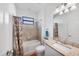 Well-lit bathroom with a bathtub, shower and sink with granite countertops at 1951 E Isles Rd, Port Charlotte, FL 33953