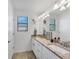 A simple bathroom features a double sink and granite countertops at 1951 E Isles Rd, Port Charlotte, FL 33953