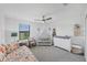 Cozy Bedroom with crib, rocking chair, and window overlooking the community at 1951 E Isles Rd, Port Charlotte, FL 33953