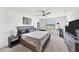 A neutral bedroom boasts a ceiling fan, a large bed, a window, and neutral-colored decor at 1951 E Isles Rd, Port Charlotte, FL 33953