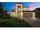 Beautiful two-story home with a well-maintained lawn, landscaping, and a two-car garage at 1951 E Isles Rd, Port Charlotte, FL 33953